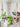 3 styles of jute plant hangers  with plants against a light gray wall