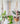 3 styles of jute plant hangers  with plants against a light gray wall